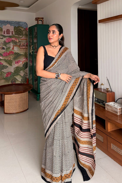 Model styling a black and white checked cotton saree for elegant corporate office wear look