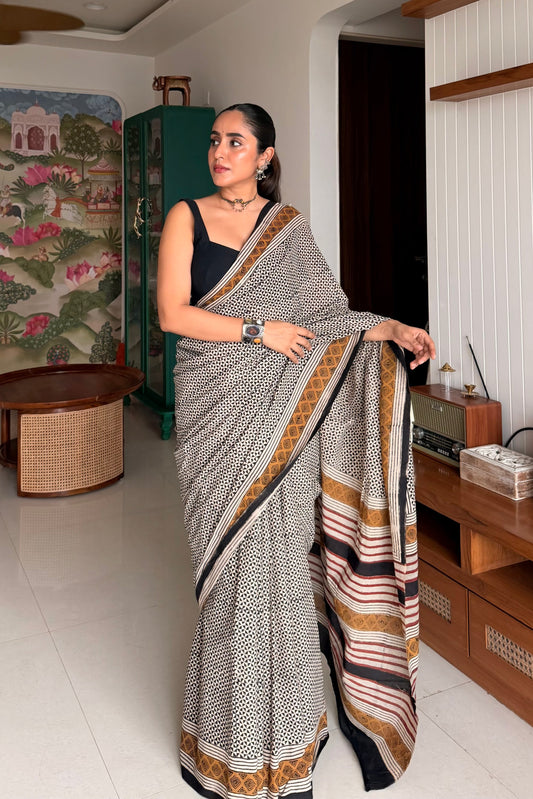 Model styling a black and white checked cotton saree for elegant corporate office wear look