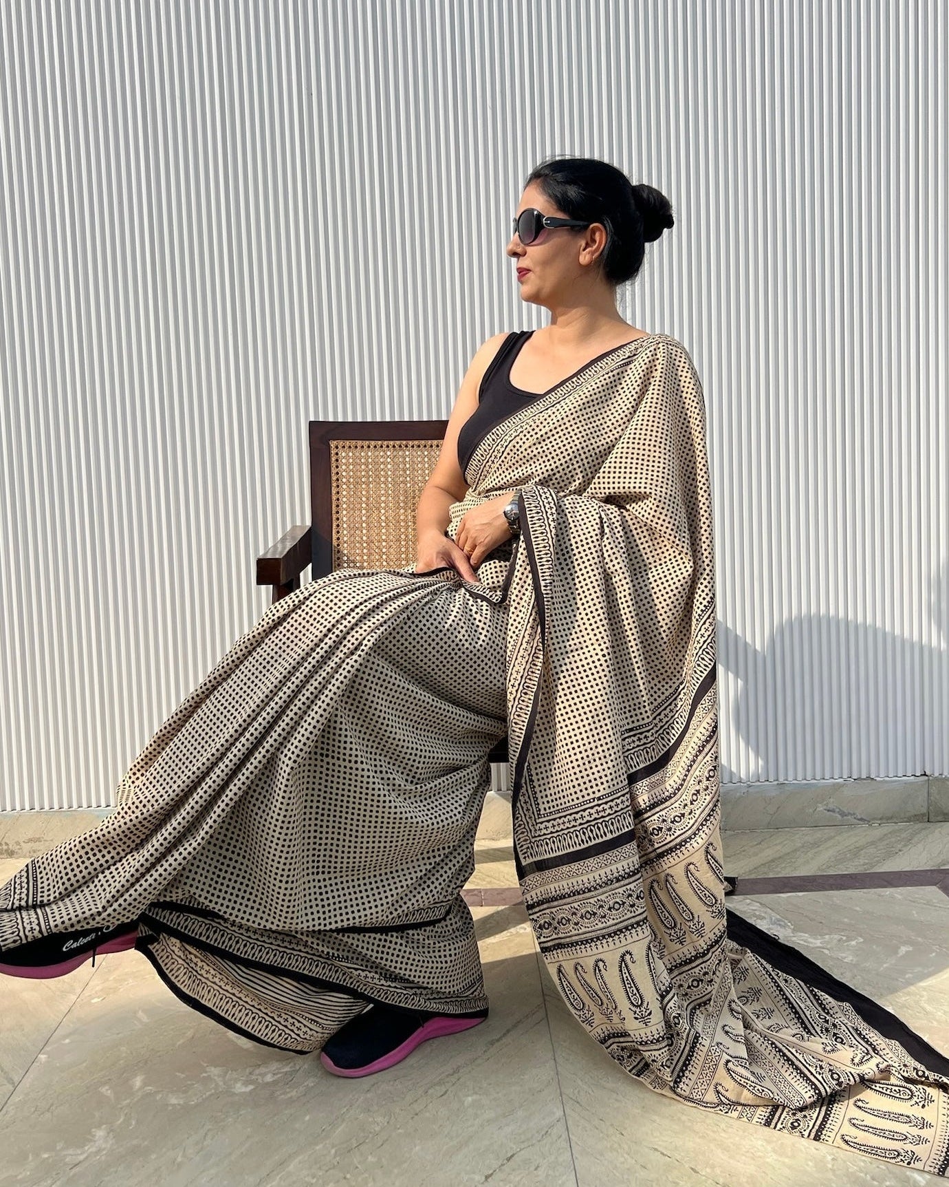 Model styling a black and white checked cotton saree for elegant corporate office wear look
