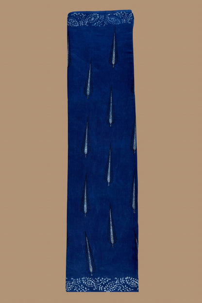 Blue fabric with white embroidery on a brown background