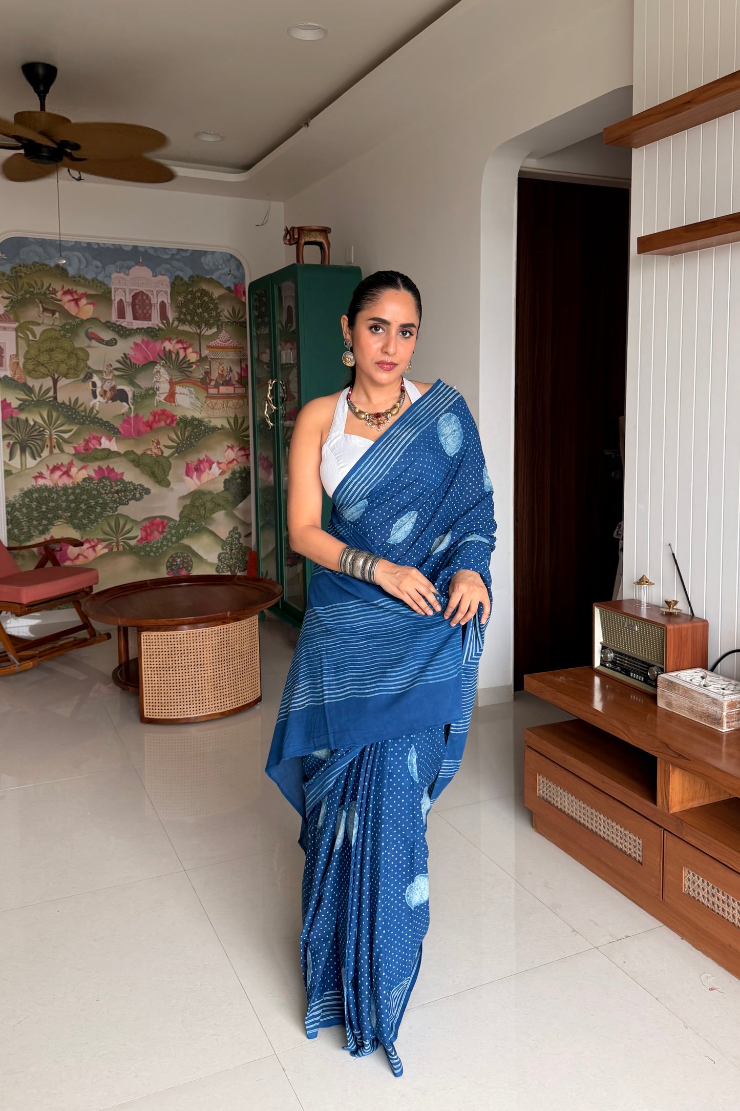 Woman styling an indigo blue cotton Dabu saree for summer ethnic wear.